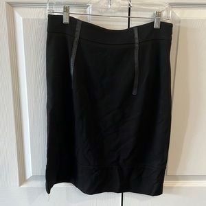 Black, below the knee length, skirt with black leather highlights.